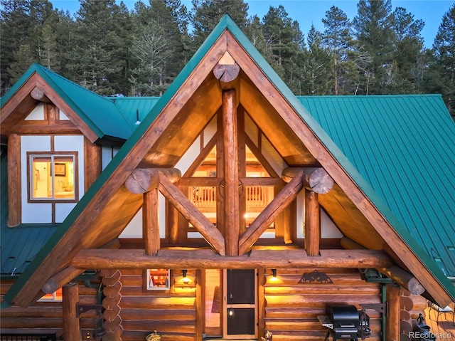 exterior space with metal roof and log exterior