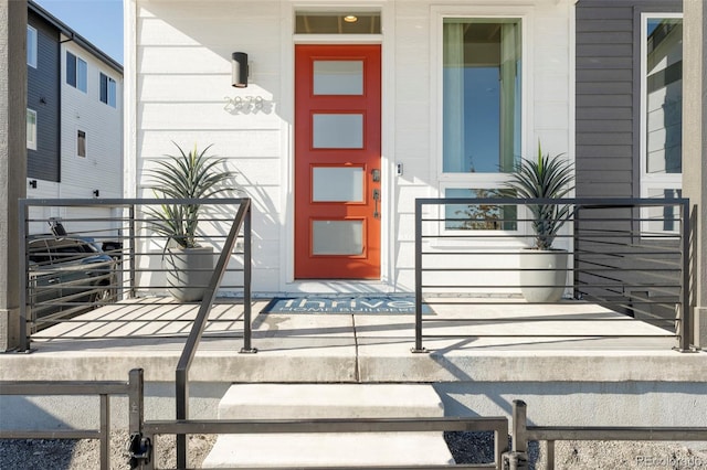 view of exterior entry featuring covered porch