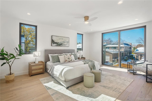 bedroom with ceiling fan, access to exterior, multiple windows, and light hardwood / wood-style flooring