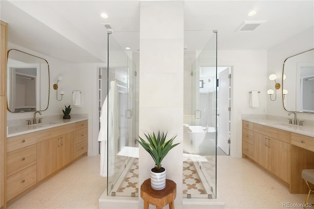 bathroom featuring vanity and a shower with shower door