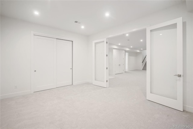 basement featuring light carpet