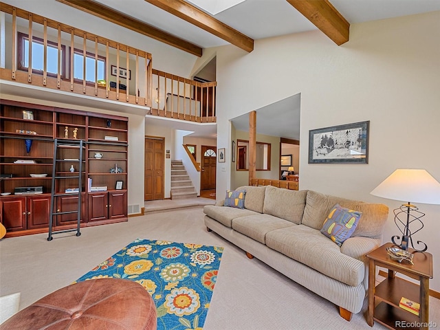 31412 N Bermuda Dunes Dr, Evergreen, CO 80439 - living room with light colored carpet, stairway, beam ceiling, and a towering ceiling