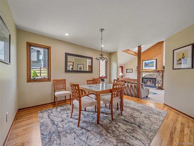 31412 N Bermuda Dunes Dr, Evergreen, CO 80439 - dining room with baseboards, a stone fireplace, light wood-type flooring, a chandelier, and recessed lighting