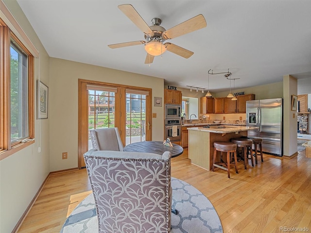 31412 N Bermuda Dunes Dr, Evergreen, CO 80439 - dining area featuring light wood-style floors, a ceiling fan, and baseboards