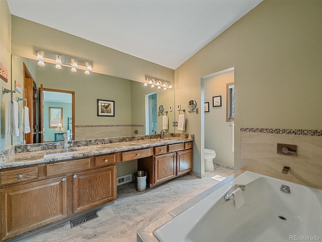 31412 N Bermuda Dunes Dr, Evergreen, CO 80439 - bathroom featuring lofted ceiling, double vanity, toilet, a garden tub, and marble finish floors