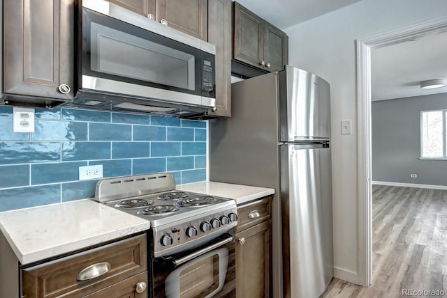 361 N Raleigh St, Denver, CO 80219 - kitchen with stainless steel appliances, light wood-style floors, backsplash, and light countertops