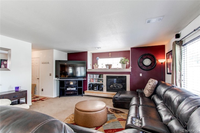 5400 Perth St, Denver, CO 80249 - living area with healthy amount of natural light, carpet flooring, a tiled fireplace, and baseboards