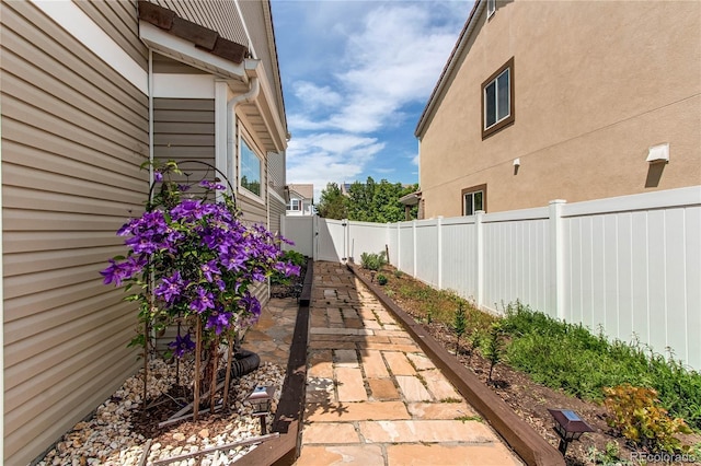 5400 Perth St, Denver, CO 80249 - view of side of home with a fenced backyard, a patio area, and a gate