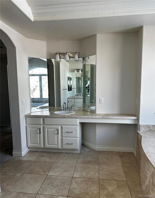 bathroom featuring vanity, tile patterned floors, and a textured ceiling