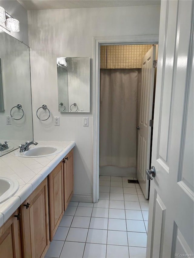 bathroom with tile patterned floors and vanity