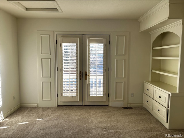 entryway with light carpet and french doors