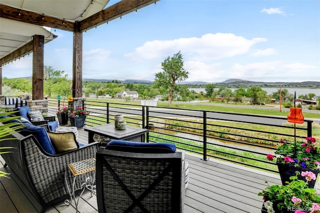 balcony featuring a water and mountain view