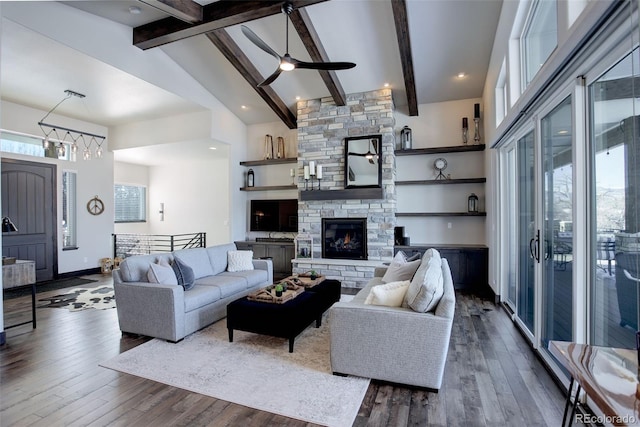 living room featuring high vaulted ceiling, dark wood-style flooring, and a stone fireplace