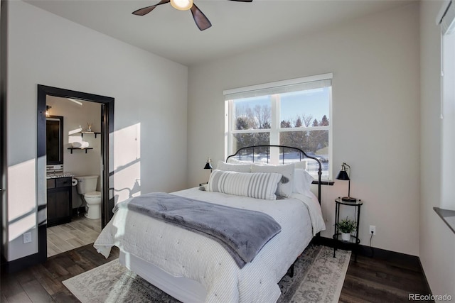 bedroom featuring dark wood-style flooring, connected bathroom, and a ceiling fan