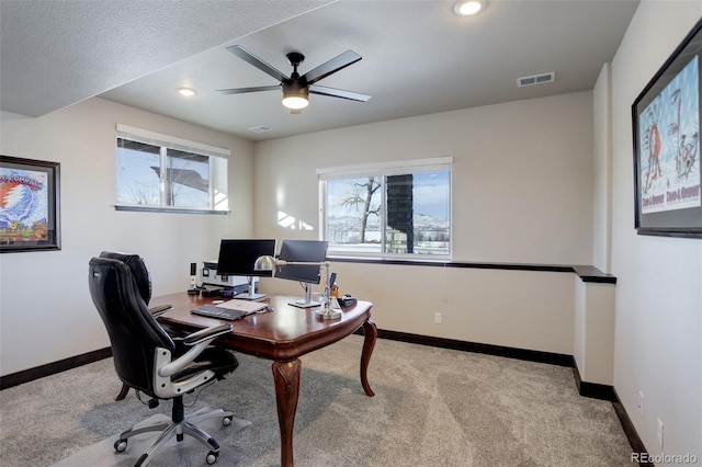 office featuring recessed lighting, visible vents, a ceiling fan, light carpet, and baseboards