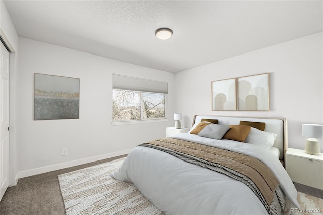 bedroom with a textured ceiling, a closet, carpet flooring, and baseboards