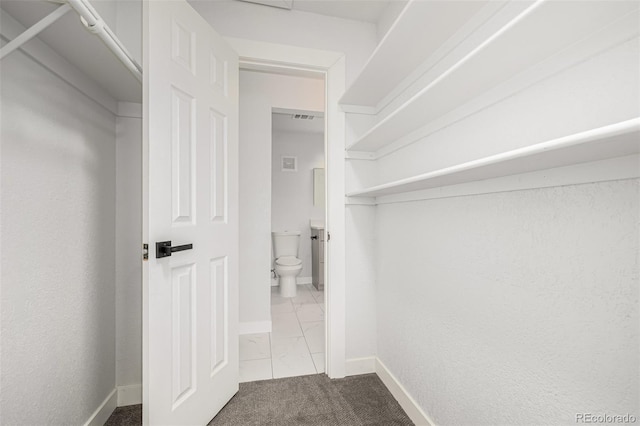 walk in closet featuring visible vents and dark carpet