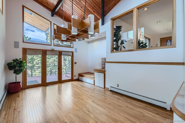 135 Poorman Rd, Boulder, CO 80302 - unfurnished living room featuring baseboard heating, a high ceiling, a wooden ceiling with exposed beams, healthy amount of natural light, and a chandelier