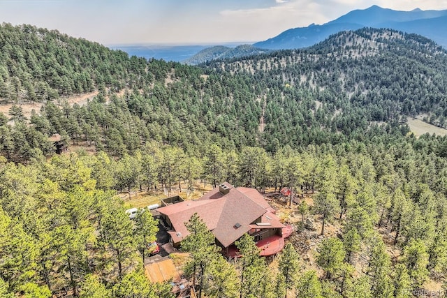 135 Poorman Rd, Boulder, CO 80302 - aerial view of property and surrounding area featuring a heavily wooded area and mountains