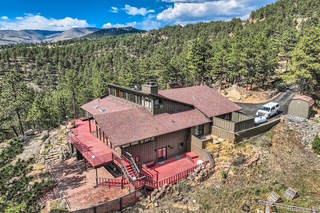 135 Poorman Rd, Boulder, CO 80302 - aerial view of property and surrounding area with a heavily wooded area and a mountainous background