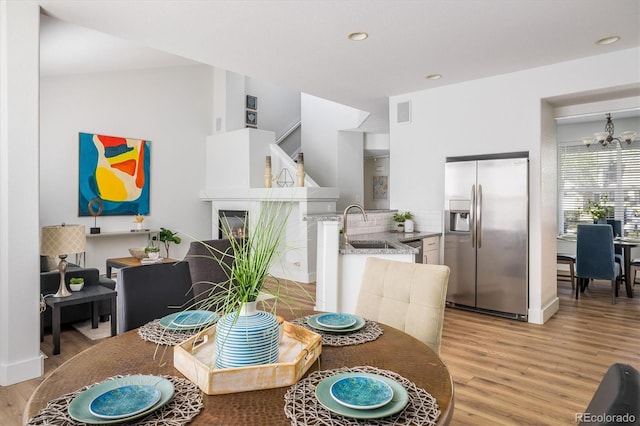 14000 Winding River Ct Unit T3, Broomfield, CO 80023 - dining space with light wood-style floors, a chandelier, and recessed lighting