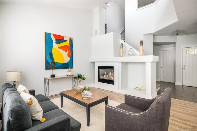 14000 Winding River Ct Unit T3, Broomfield, CO 80023 - living room featuring high vaulted ceiling, a glass covered fireplace, and wood finished floors