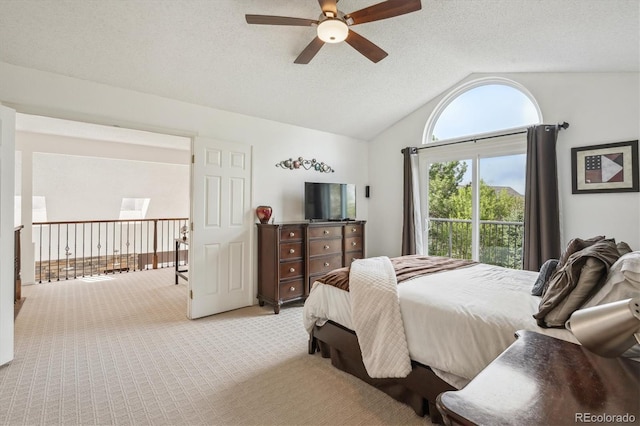 bedroom featuring light colored carpet, a textured ceiling, lofted ceiling, and ceiling fan