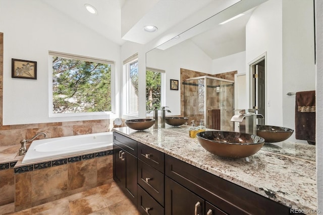 bathroom with a sink, lofted ceiling, and a shower stall