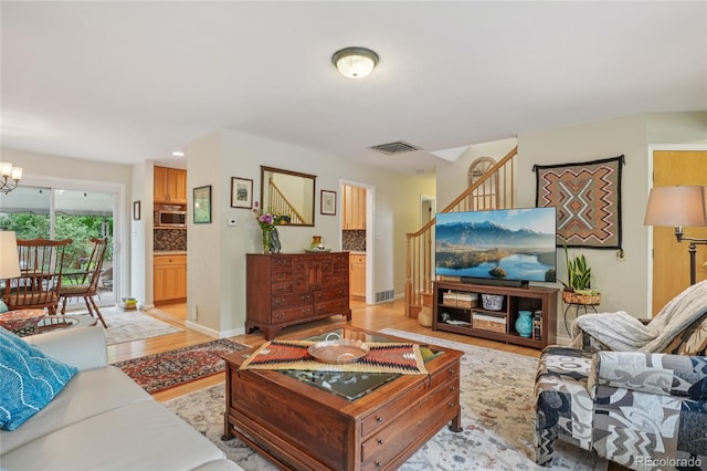 40 S 34th St, Boulder, CO 80305 - living area with stairway, a chandelier, and light wood-style floors