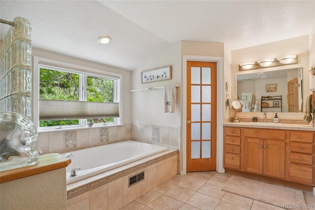 40 S 34th St, Boulder, CO 80305 - bathroom with vanity, a bath, tile patterned floors, and vaulted ceiling
