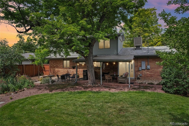 40 S 34th St, Boulder, CO 80305 - back of property at dusk featuring a patio and brick siding