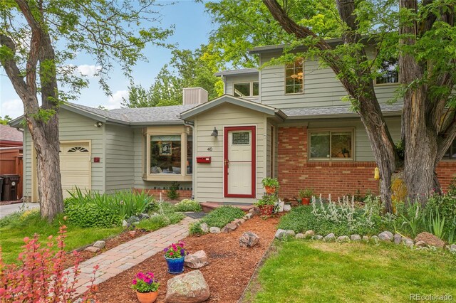 40 S 34th St, Boulder, CO 80305 - view of front of house featuring an attached garage and brick siding