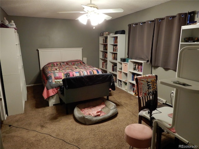 bedroom with a textured ceiling, carpet floors, and ceiling fan