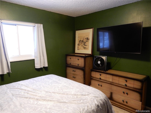 carpeted bedroom featuring a textured ceiling