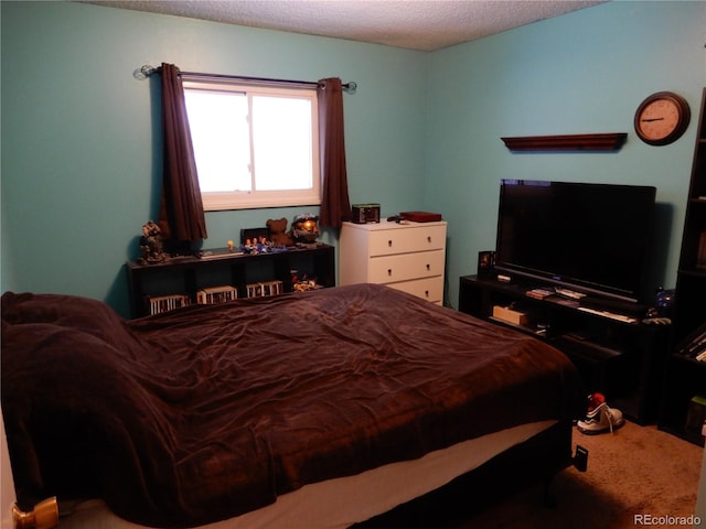 carpeted bedroom featuring a textured ceiling