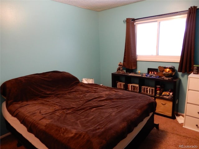 carpeted bedroom with a textured ceiling