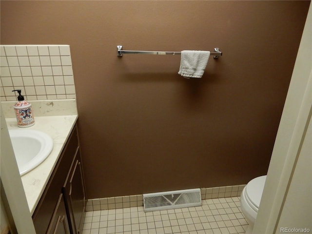 bathroom with tile patterned floors, vanity, and toilet