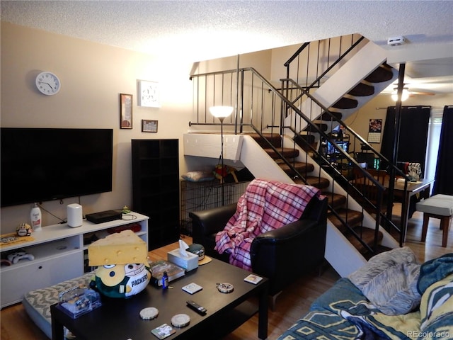 living room featuring hardwood / wood-style floors and a textured ceiling