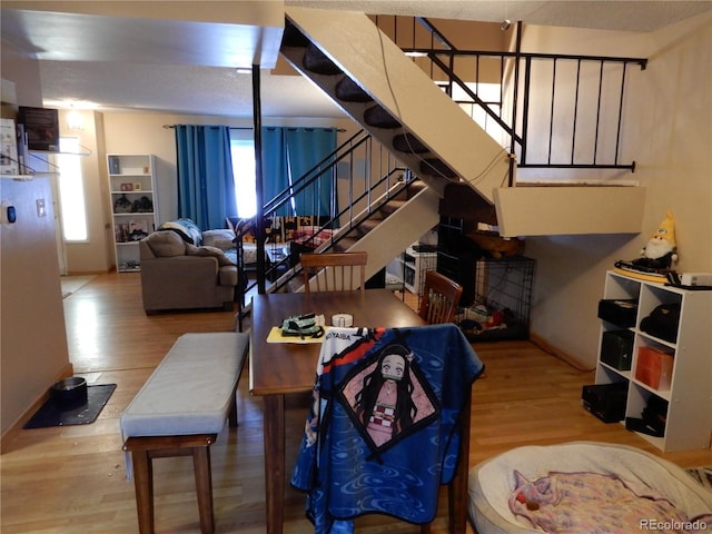 dining space with wood-type flooring