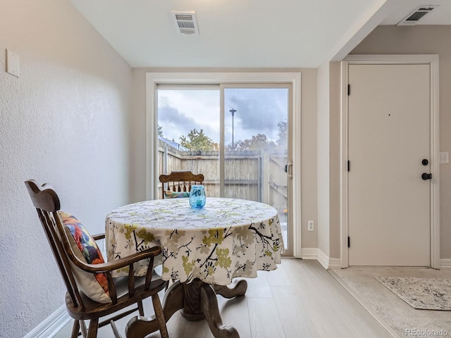 dining area with light wood-type flooring