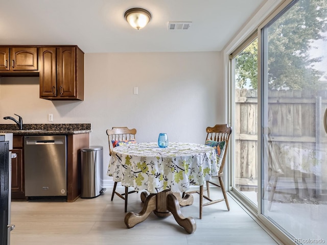 dining room with sink and light wood-type flooring