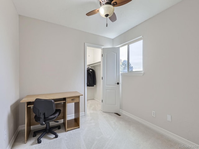 carpeted home office with ceiling fan