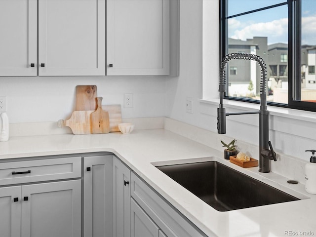 kitchen with light countertops and a sink