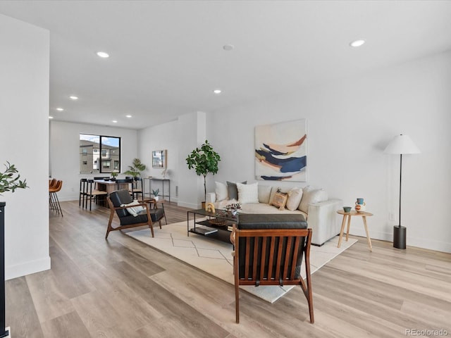 living area with recessed lighting and light wood finished floors