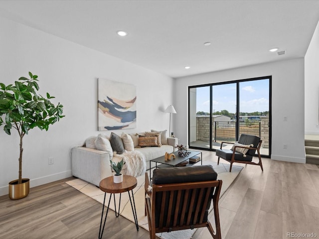 living room featuring recessed lighting, light wood-style floors, visible vents, and baseboards