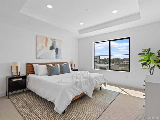 bedroom with recessed lighting, baseboards, a raised ceiling, and carpet