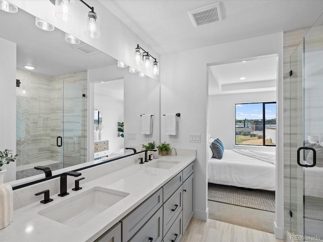 ensuite bathroom featuring a sink, visible vents, ensuite bath, and a shower stall