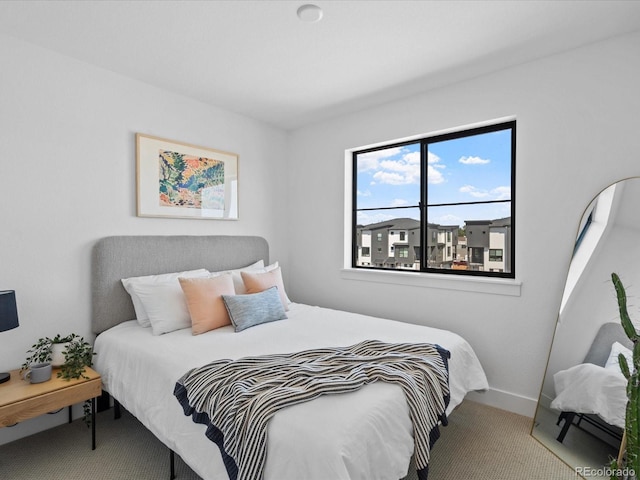 bedroom with carpet flooring and baseboards