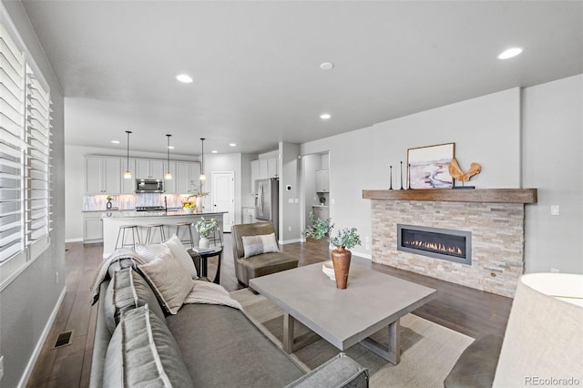 living room featuring a fireplace and dark hardwood / wood-style floors