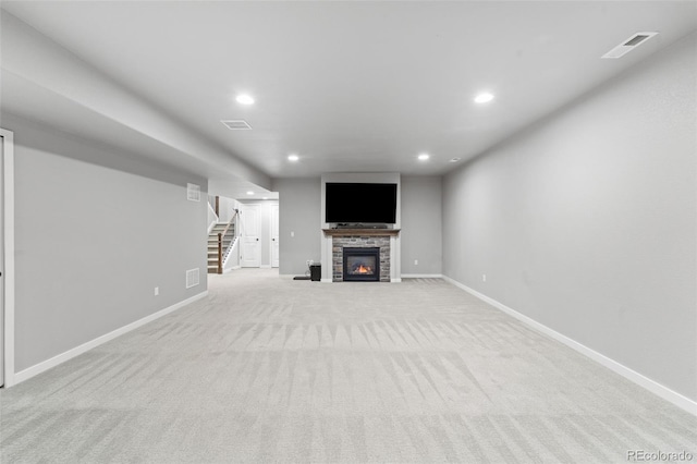 unfurnished living room with a fireplace and light colored carpet